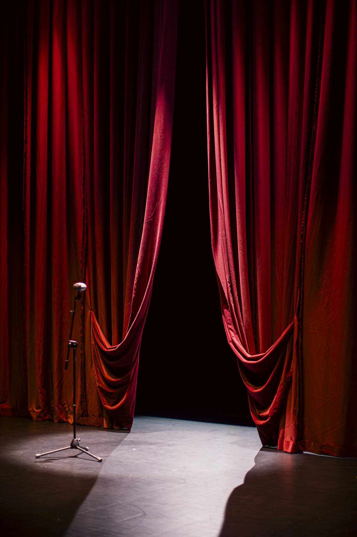 A Theater Stage With Closed Red Curtains